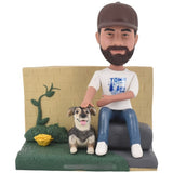 Custom Bobblehead sitting against background wall with dog